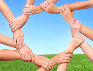 Ring of hands teamwork showing your product in nature