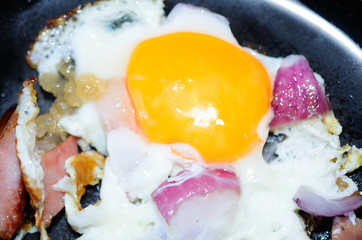 Fried egg with onion and sausage