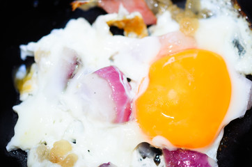 Fried egg with onion and sausage