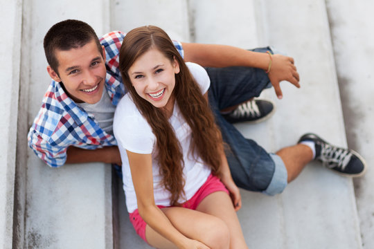 Teenage couple sitting on stairs