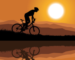 silhouette of a cyclist at sunset