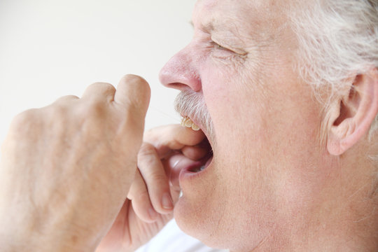 Older Man Flossing Teeth Profile View