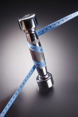 Measuring tape and dumbbell