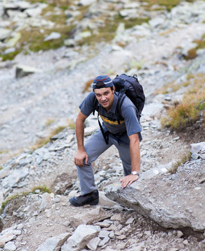 Young man hiking on mountain trail