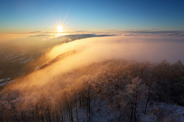Winter sunset over the clouds