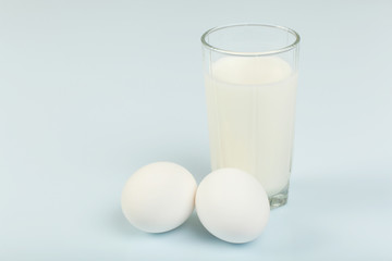 Milk in a glass jar and eggs