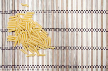 Lot of macaroni on striped background