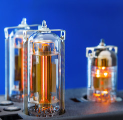 Three vacuum electron tubes on blue background
