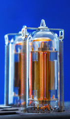 Two vacuum electron tubes on blue background