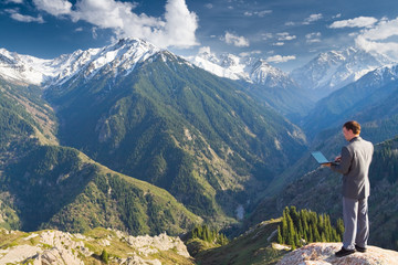 businessman at mountain using wireless network