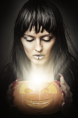Woman witch holding pumpkin