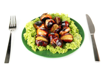 roasted chestnuts with lettuce in the green plate with fork and