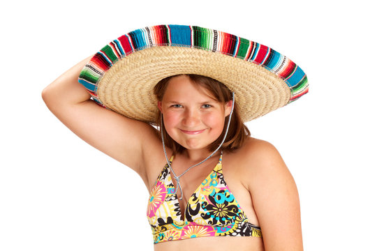 Cute smiling girl holding colorful Mexican hat on her head