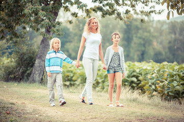 Beautiful Young Woman with Two Children Outside