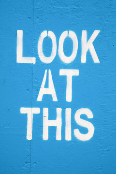 Attention seeking graffiti painted on a blue wall