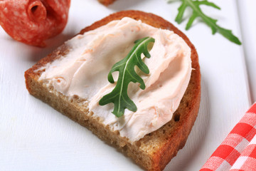 Crispy bread with spread and salami