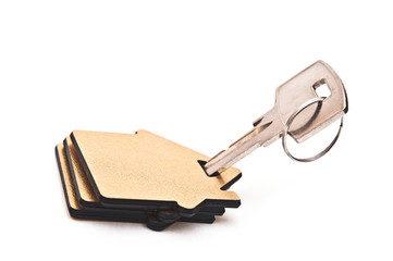 Macro view of silver key with house figure on white background