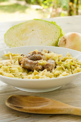 Cooked pork sausage and boiled cabbage