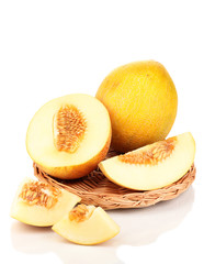 Ripe melons on wicker cradle isolated on white