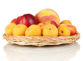 Ripe fruit on wicker mat isolated on white