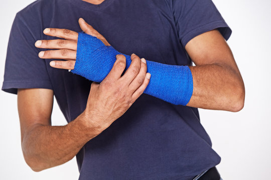 man with blue arm bandage