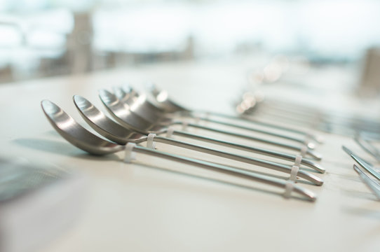 Stands with spoons, knifes and forks on tables in supermarket