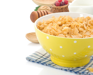 Bowl of corn flakes and milk isolated on white