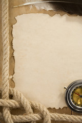 ropes and compass on old vintage ancient paper background