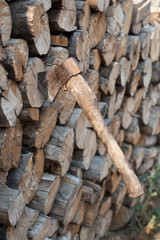 An ax sticking out in the woodpile