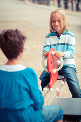 Obraz na płótnie Canvas Happy Children Playing at Playground