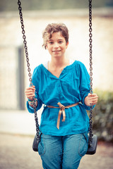 Young Girl Playing on the Swing