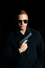 Portrait of young man with gun