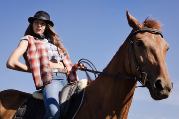Cowgirl riding a bay horse