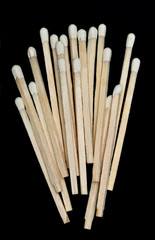 A bunch of wooden matches isolated on a black background
