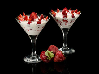 Strawberry with cream in two glasses.
