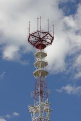 Telecommunication mast over a blue sky.