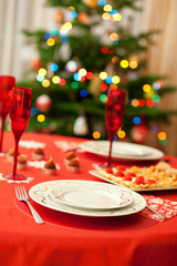 Decorated christmas dining table with champagne glasses and chri