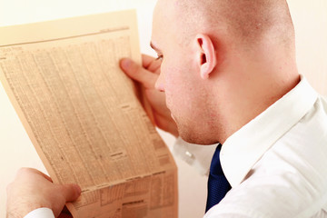 A businessman reading a newspaper