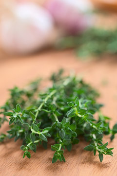 Bundle of fresh thyme with garlic in the back