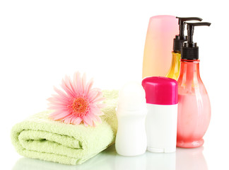 Obraz na płótnie Canvas cosmetics bottles with towels and flower isolated on white