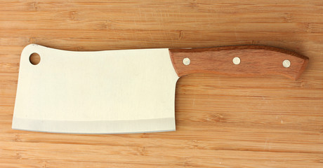 meat cleaver on wooden background close-up