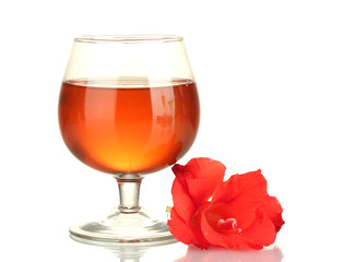 glass with cocktail and gladiolus bud isolated on white