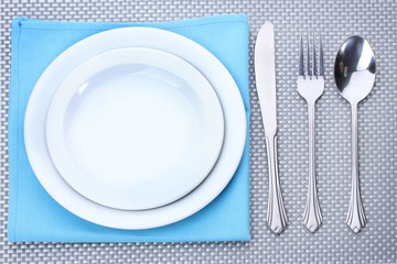 White empty plates with fork, spoon and knife