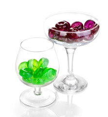 Color candies in glasses isolated on white