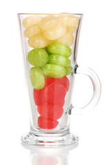 Color candies in glass isolated on white