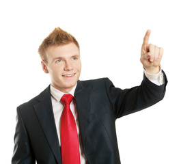 A young man pointing something isolated on white background
