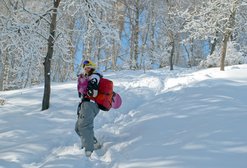 Sport women going for freeride with snowboard