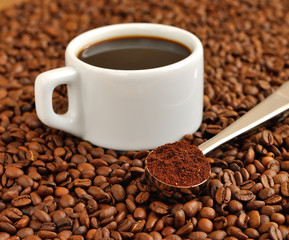 Coffee in a cup on the background of coffee beans