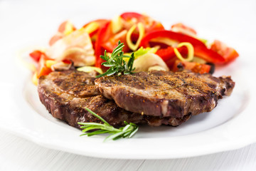 Grilled pork steaks with salad