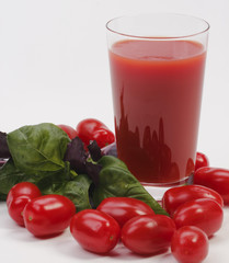 Glass of juice with tomato and basil